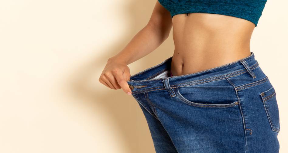 front-view-young-female-with-fit-body-shirt-jeans-white-wall (1)